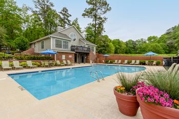A swimming pool with a house in the background